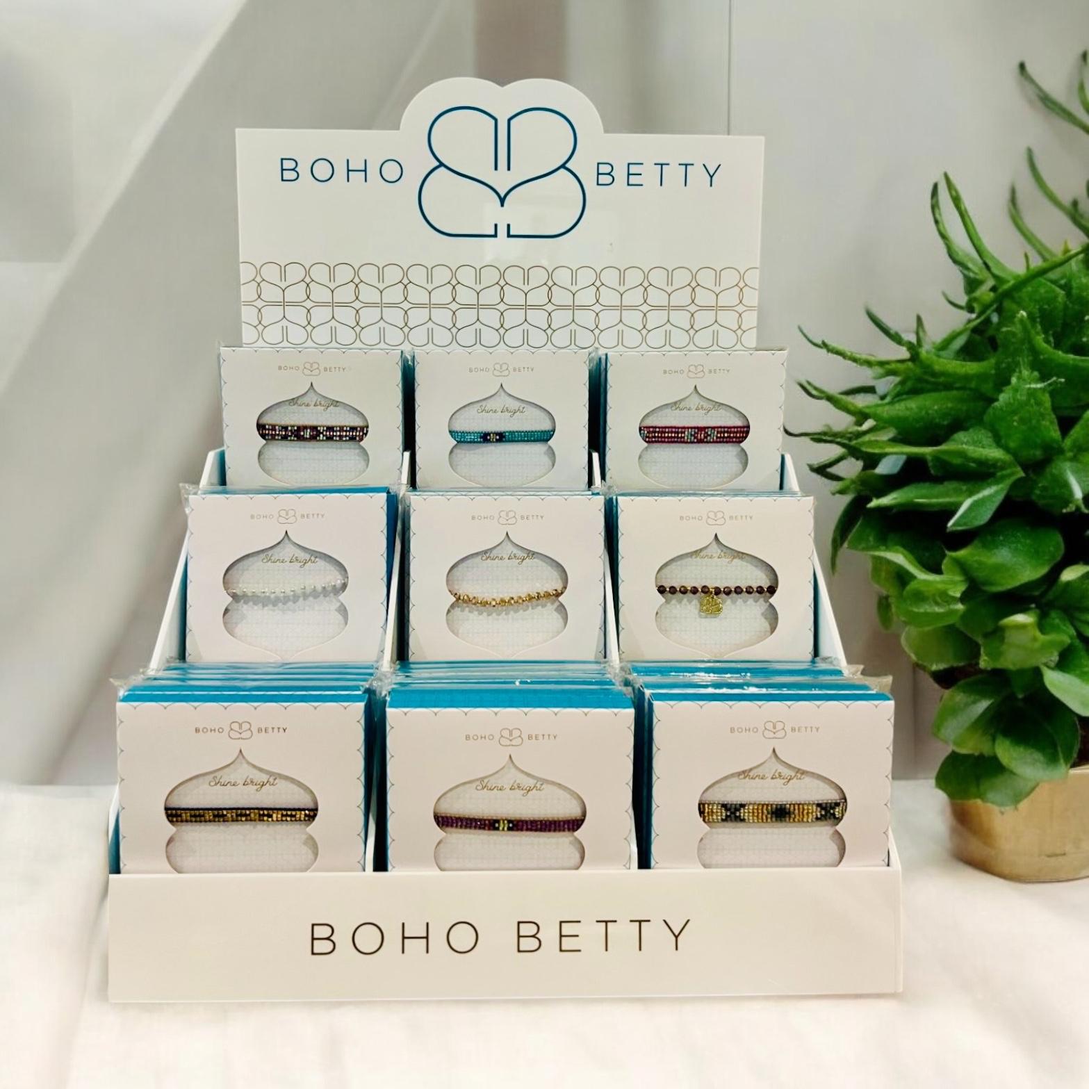 Boho Betty Acrylic stand containing, Braid, Prunus and Miyuki Bead 3 and 5 Row Bracelets.
