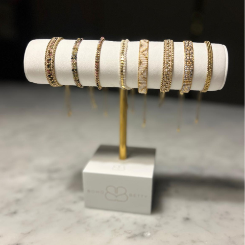 Boho Betty single T-bar stand with bracelets elegantly displayed on white faux suede, set against a neutral background.