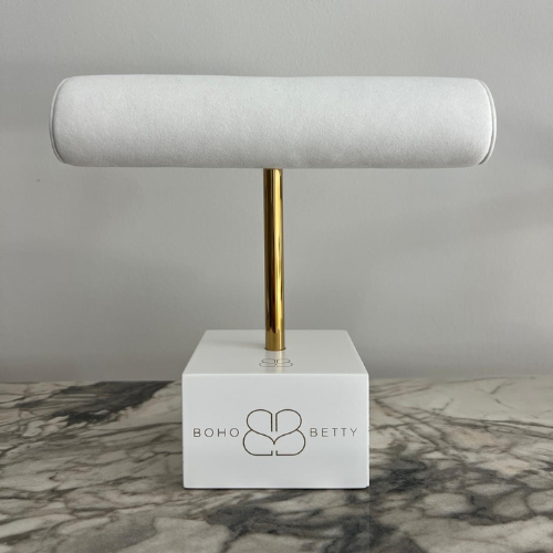 Single faux suede T-bar jewellery stand by Boho Betty with a gold support and white base, ideal for bracelets or bangles.