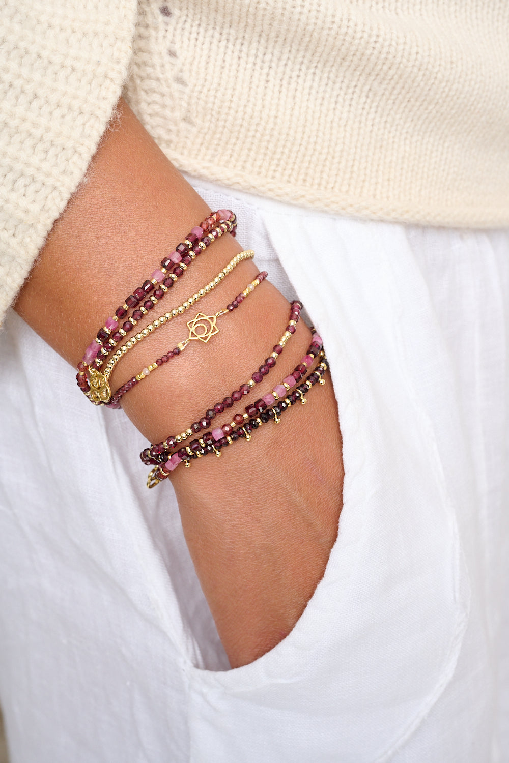Annabelle Wrap Bracelet styled with rich red and pink gemstone stacks, golden tones, and a layered boho look.