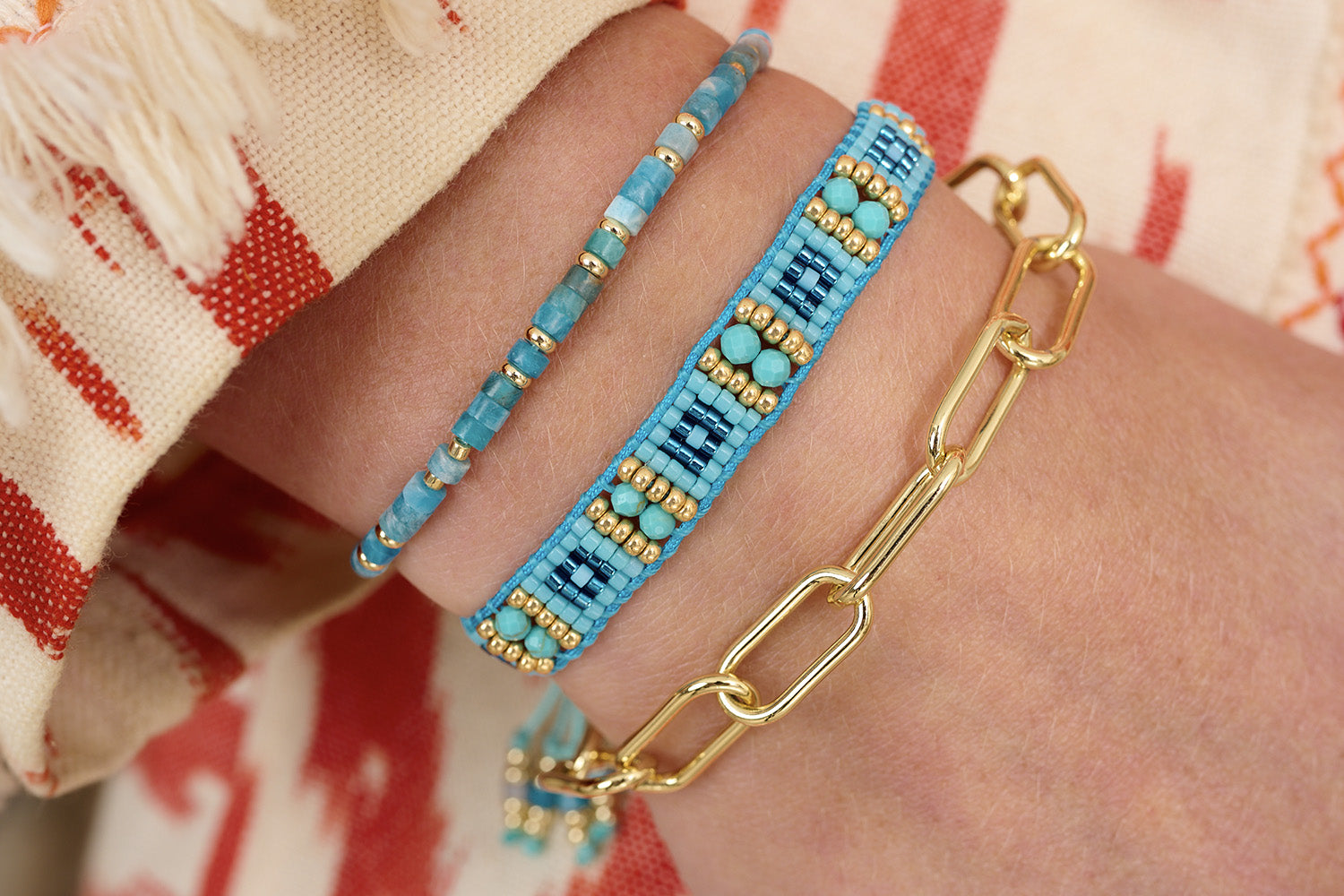 Aruba Apatite & Gold Bracelet Stack styled with summery boho vibes—layered Apatite beads, woven turquoise threads, and a bold gold chain for effortless tropical charm.
