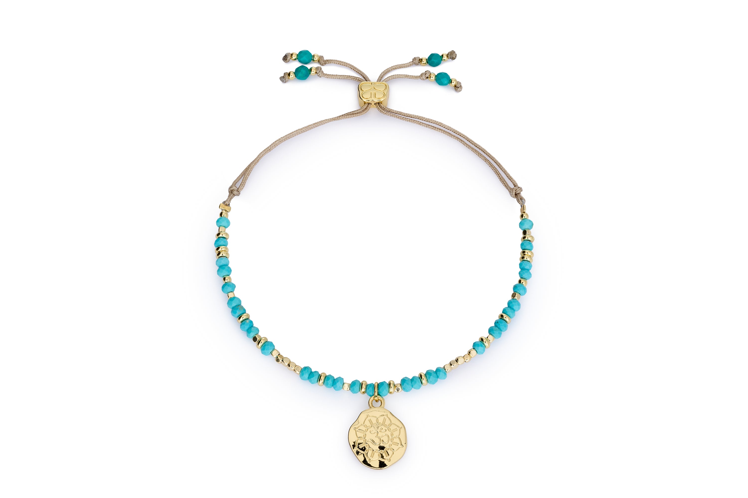 Turquoise howlite Om charm bracelet with gold accents and Boho Betty slider on white background