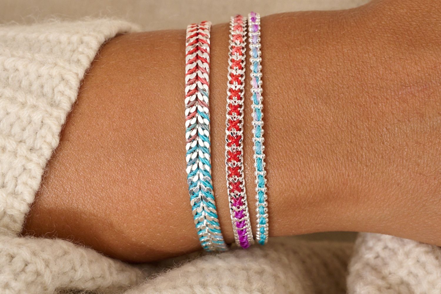Banda Moroccan Spice Silver Stacking Bracelets styled on the wrist, vibrant spice-toned woven threads and silver chain layers inspired by Moroccan colour palettes.