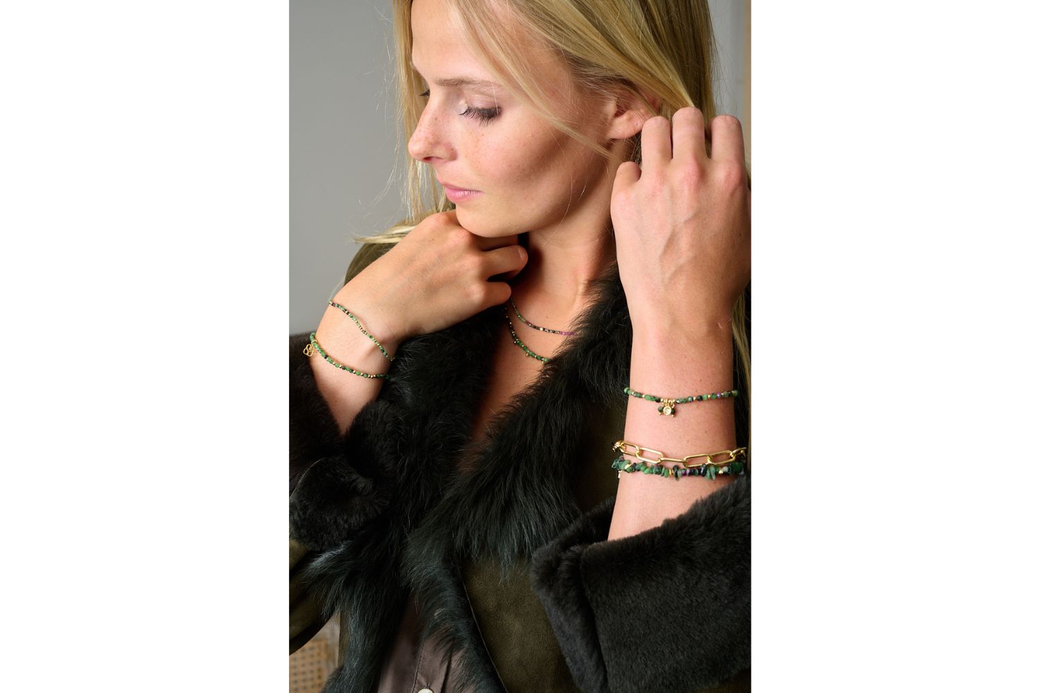 Basilia Ruby Zoisite Bracelet styled on wrist with Boho Betty stacking bracelets, featuring gold details and boho charm drops.