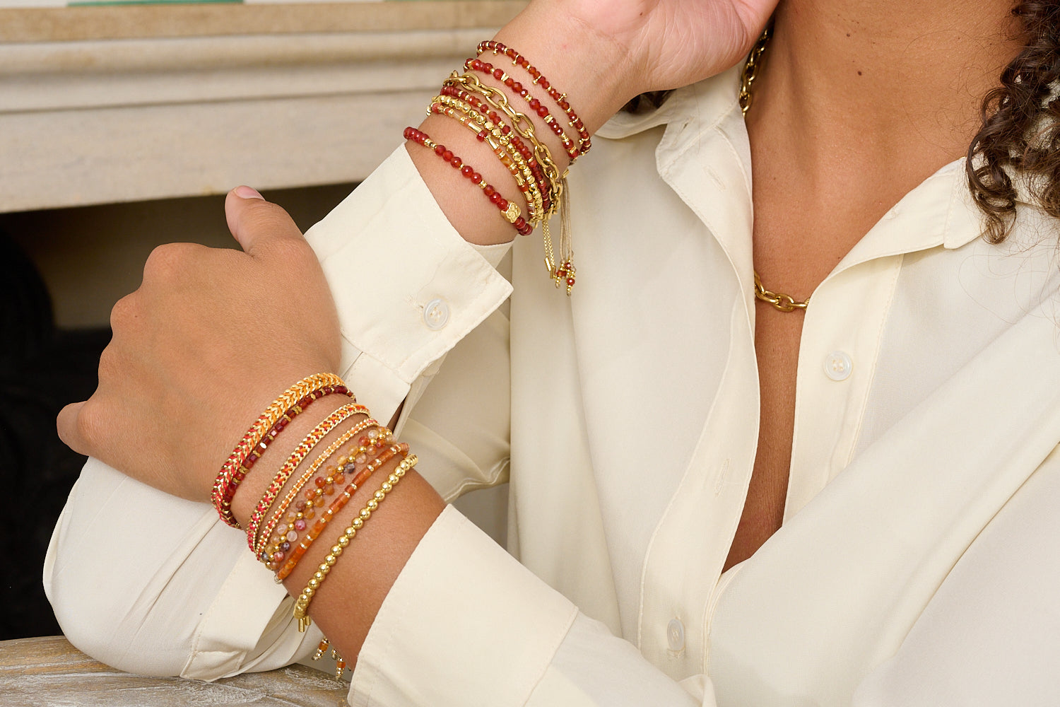 Bliss Red Agate Gold Bracelet styled on a wrist, showcasing bold gemstone colour, natural thread, and golden detailing, perfect as a July birthstone or meaningful gift.