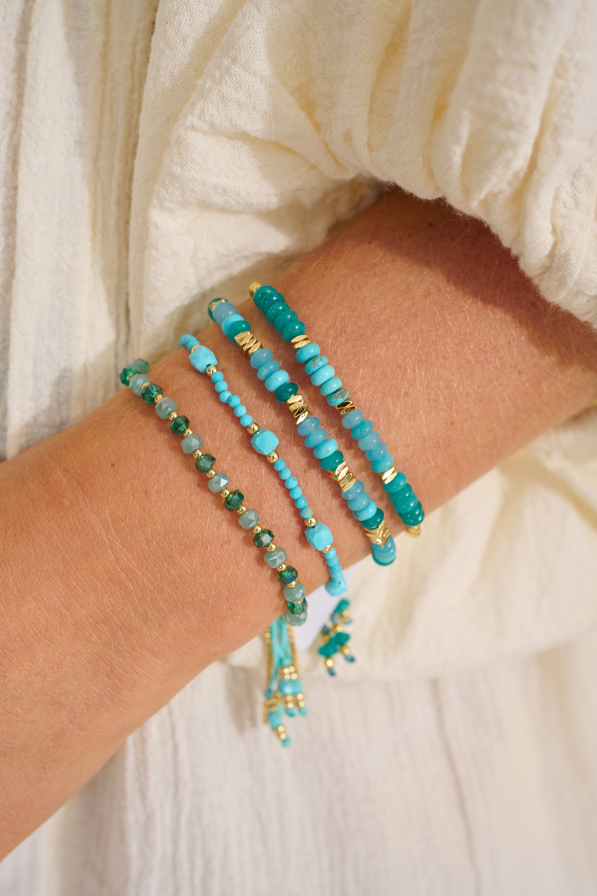 Carmine Gold, Turquoise Howlite & Jade Bracelet styled on the wrist, showcasing turquoise and jade beads with gold accents—perfect for stacking or wearing solo.