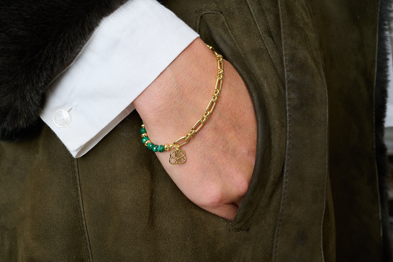 Dahlia Malachite Gold Bracelet styled with green gemstone beads, golden accents and chain detailing in a boho bracelet stack.