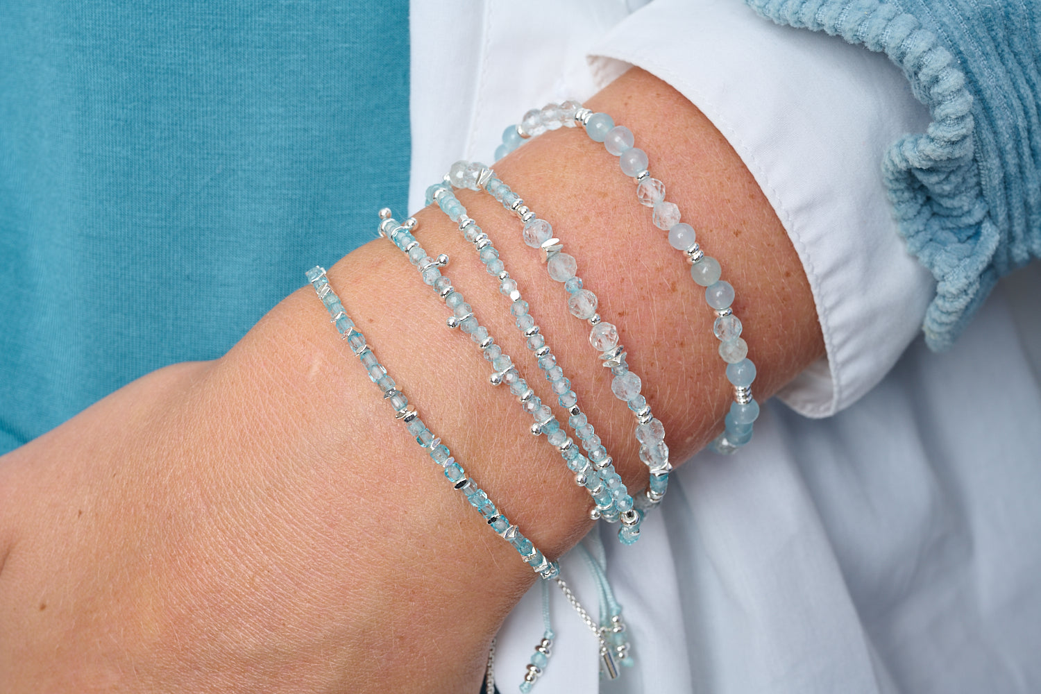Dash Silver & Blue Topaz Bracelet styled with silver-toned Boho Betty pieces on wrist, radiating soft blue sparkle and peaceful energy in a minimalist stack.