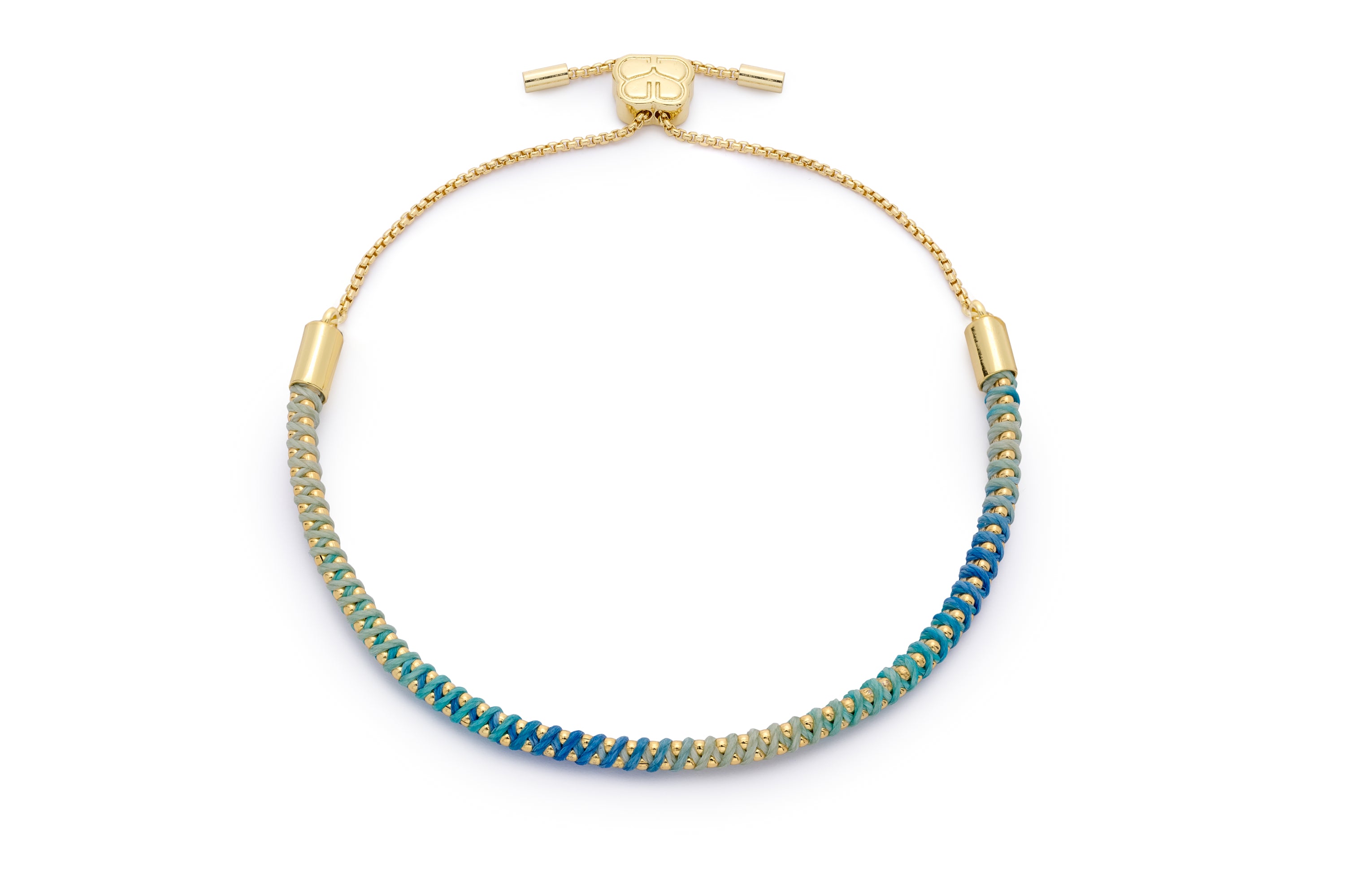 Emelia Ombre Blue & Gold Braided Bracelet featuring a handwoven ombré cord in gradient blues, wrapped around a gold-plated chain with an adjustable slider fastening.