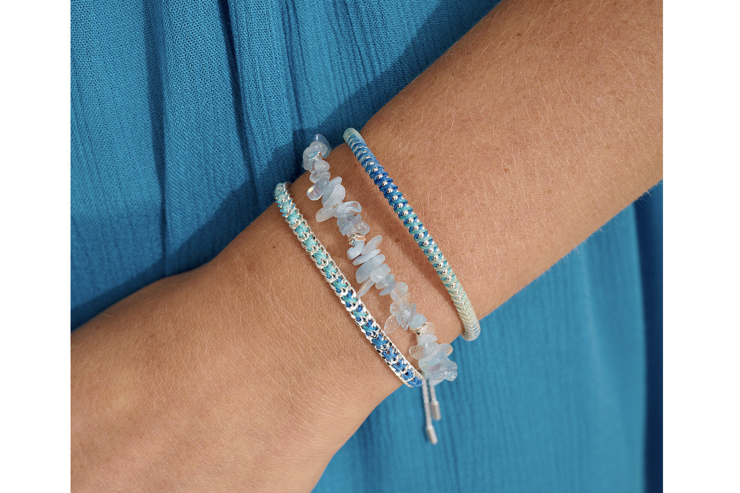 Emelia Ombre Blue Braided Bracelet styled on the wrist, showcasing its gradient tones and polished silver chain—perfect for layering or wearing solo.