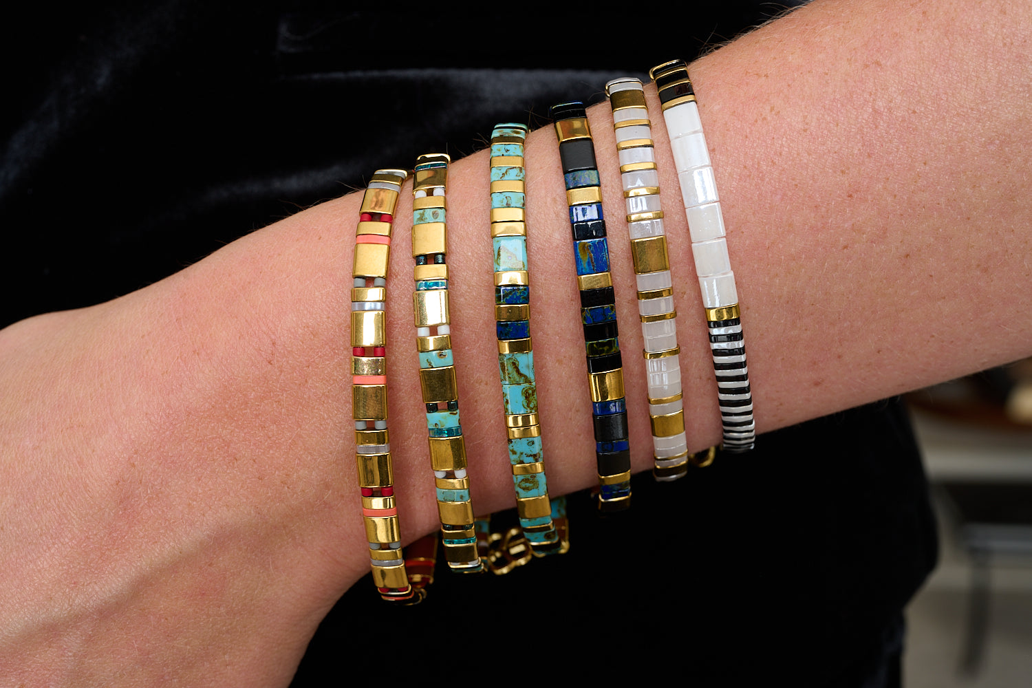 Fantasy Gold & Navy Tila Bracelet styled with navy, black, and gold striped beads in a bold boho bracelet stack.