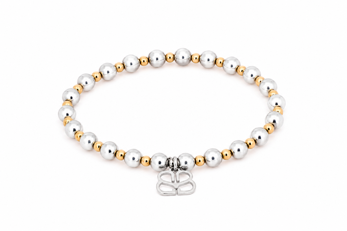 Gemma Silver Mixed Metal Bead Bracelet featuring polished silver and gold-tone beads, a signature BB filigree charm and Gold and White Gold PVD-coated stainless steel.