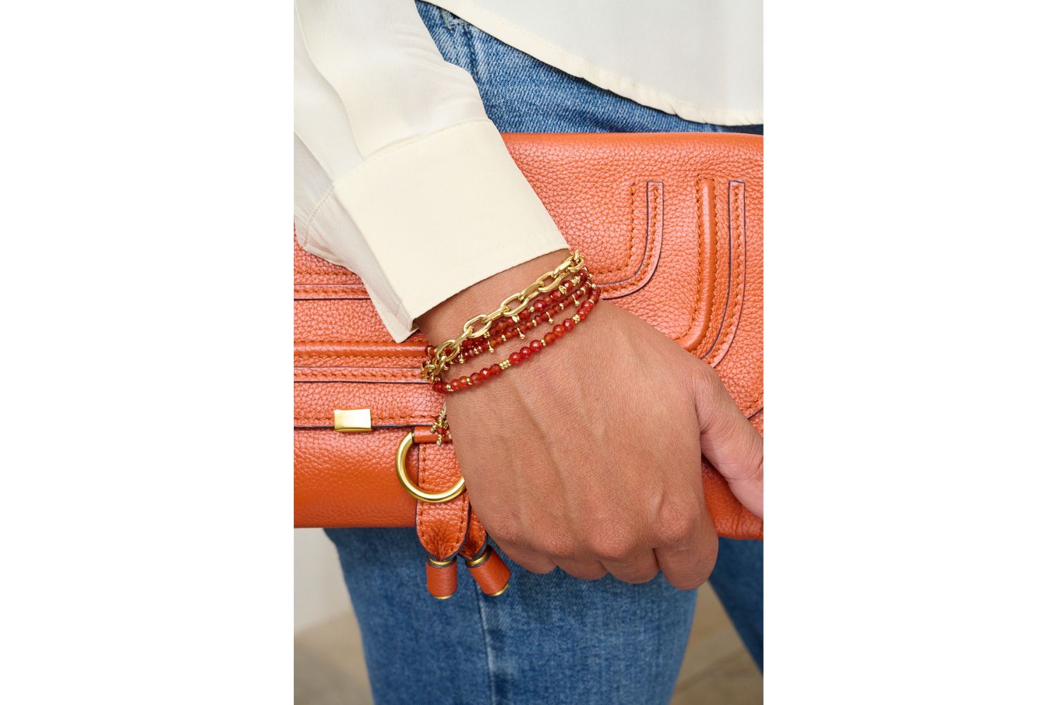 Harmony Gold & Red Agate Gemstone Bracelet styled on a wrist, showcasing its intense red agate, gold details, and confident, powerful boho aesthetic, perfect for facing the day with daring.
