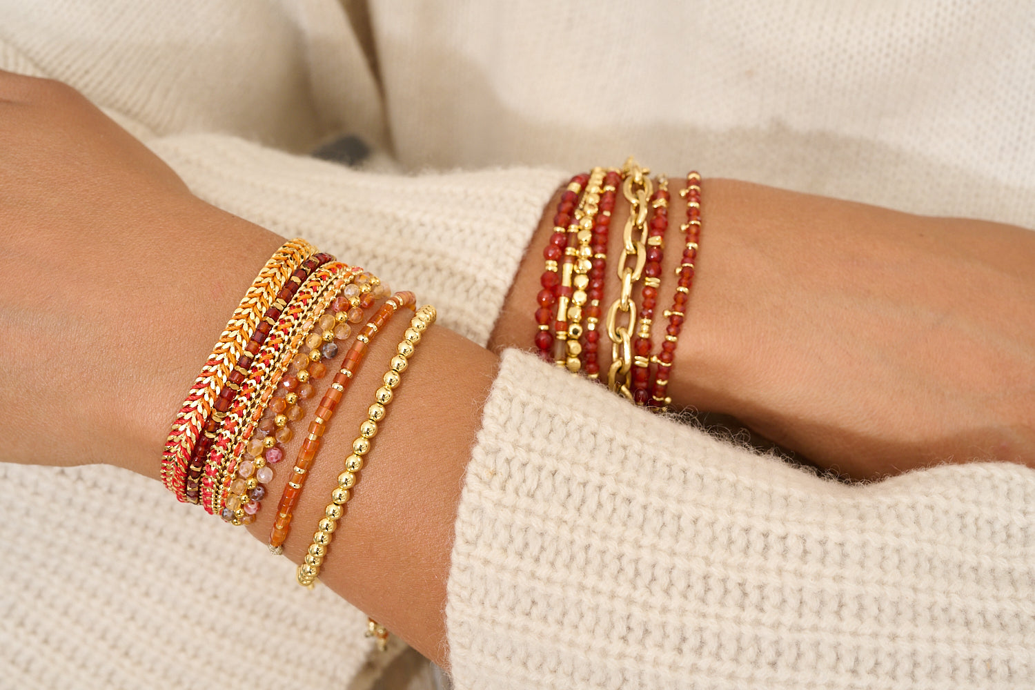 Liv Red Agate Gold Bracelet styled on a wrist, showcasing soft orange-pink gemstone cubes, golden accents, and a grounding, elegant design.