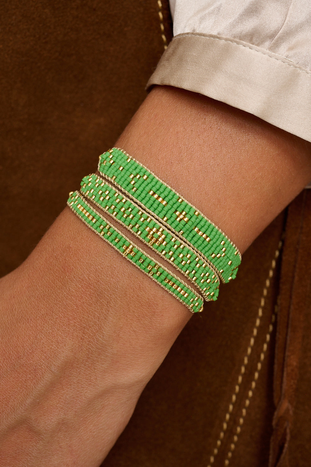 Maya green and gold bracelet featured on wrist with Boho Betty stacking bracelets
