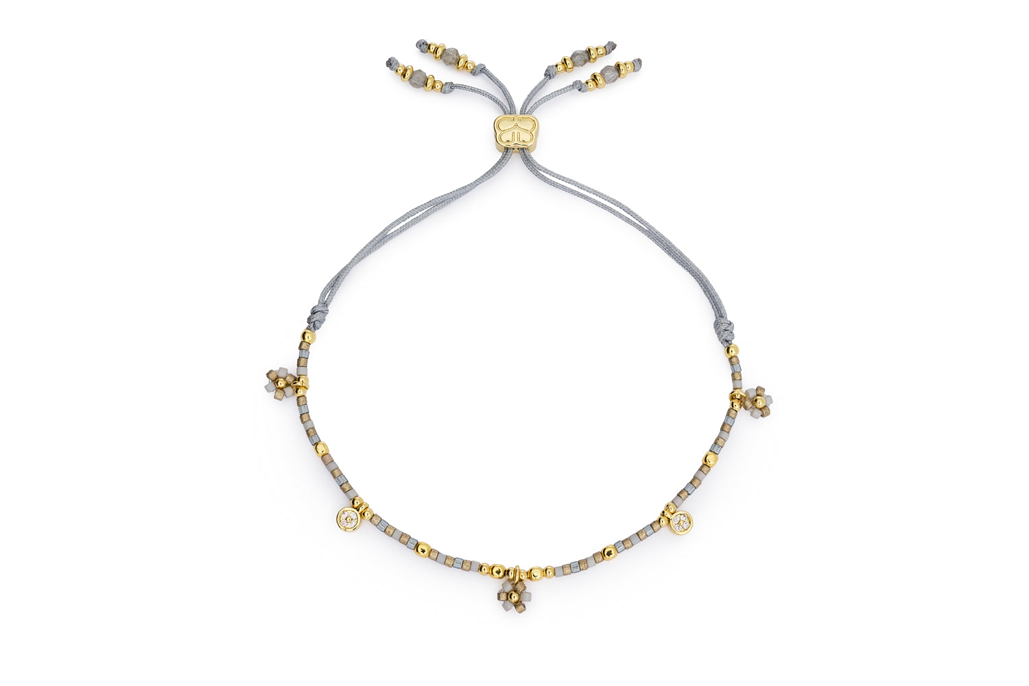 Rania Grey & Gold Beaded Charm Bracelet with matte grey Miyuki beads, golden floral charms, and adjustable cord slider for relaxed styling.