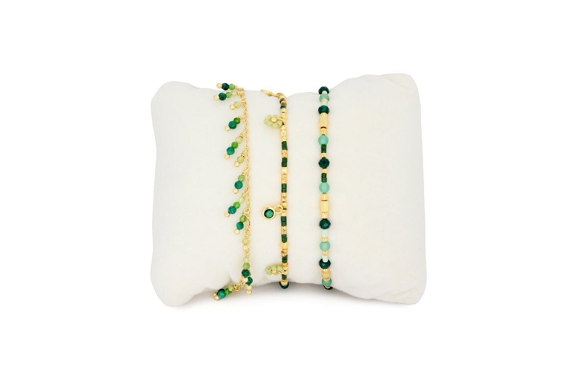 Silba Malachite and Gold Bracelet Stack featuring layered green gemstone bracelets, gold chain textures and beaded boho-inspired details.