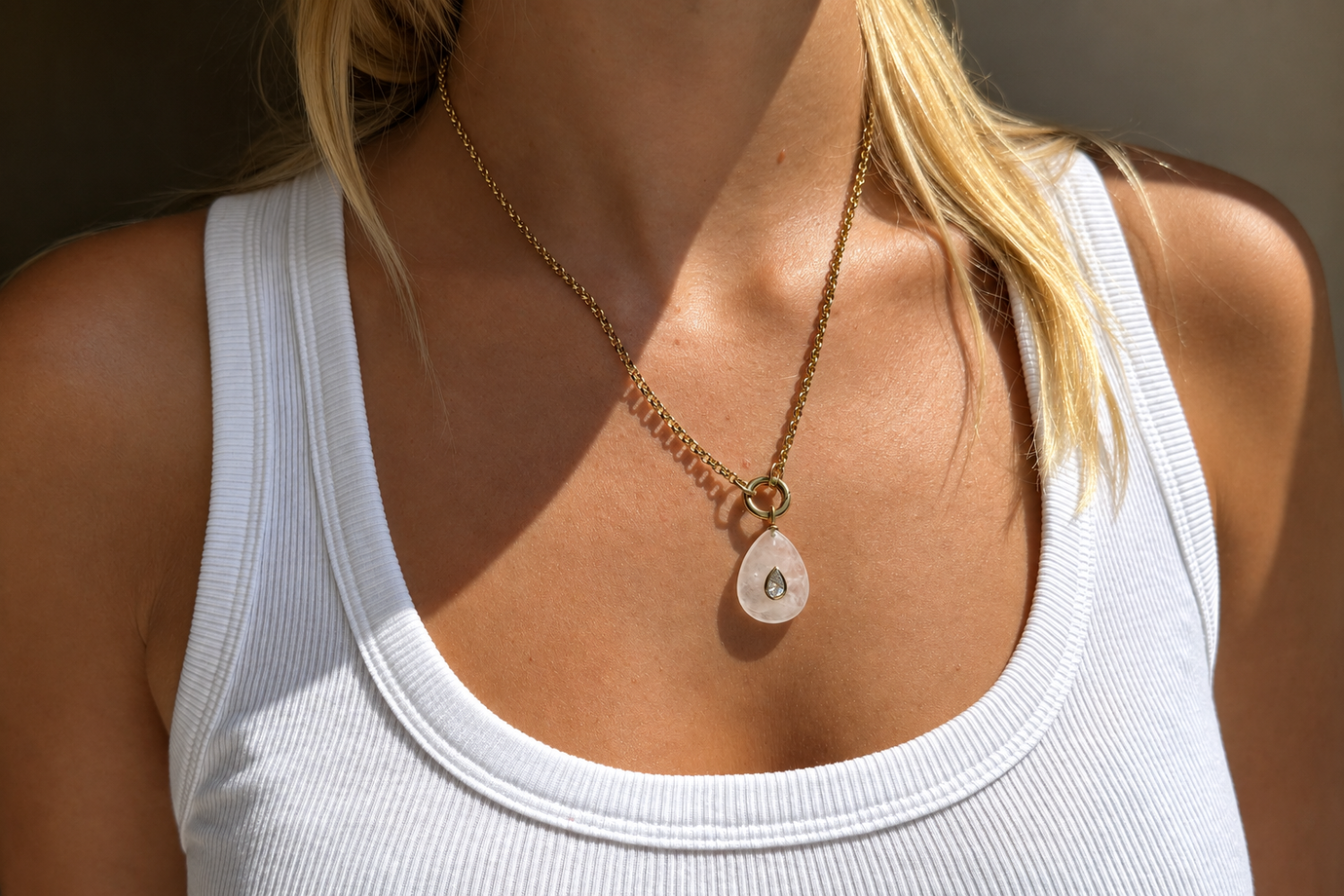 Thalia Long Clear Quartz Teardrop Pendant Necklace worn with a clear quartz pendant on a long waterproof 14k gold PVD chain for effortless layered styling.