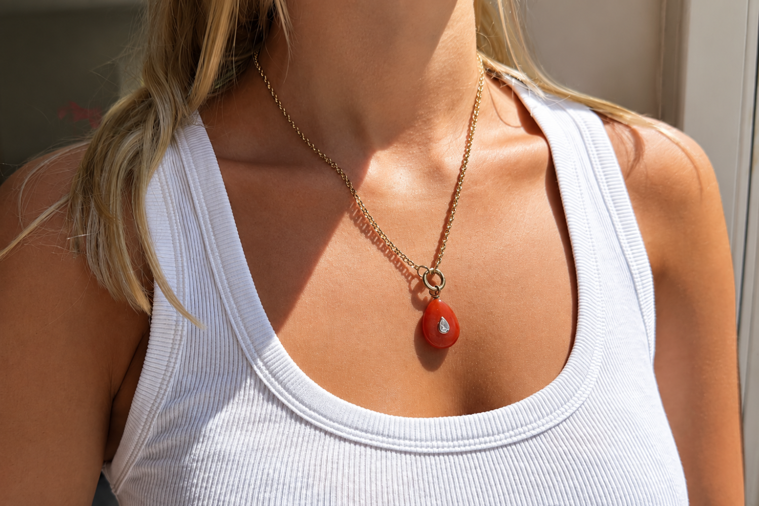 Thalia Long Red Aventurine Teardrop Pendant Necklace worn with a red aventurine pendant on a long waterproof 14k gold PVD chain for elegant layered styling.