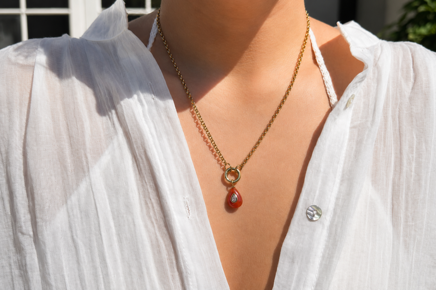 Thalia Short Red Aventurine Teardrop Pendant Necklace worn layered on the neckline with a red aventurine pendant and waterproof 14k gold PVD chain.