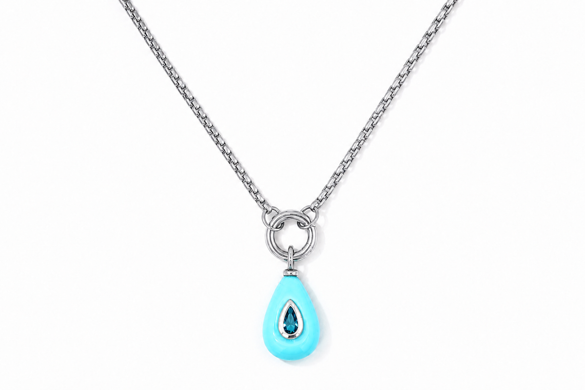 Thalia Short Turquoise Howlite Teardrop Pendant Necklace featuring a turquoise howlite gemstone with a blue crystal on a waterproof stainless steel chain.