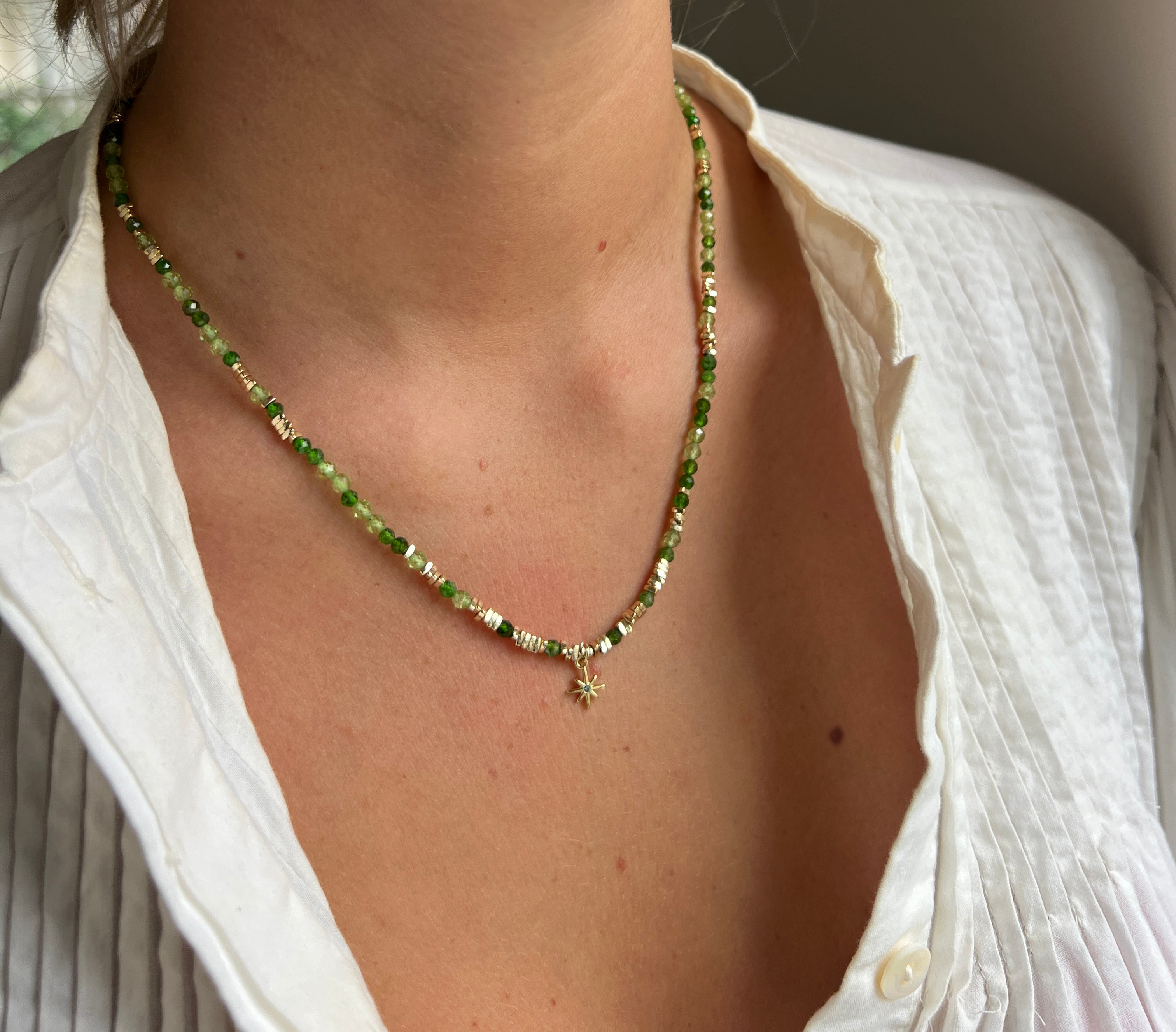 Yolanda Peridot Mix Gold Layering Necklace styled on the neck, showcasing radiant Peridot gemstones, gold accents, and a whimsical star charm for effortless layering.