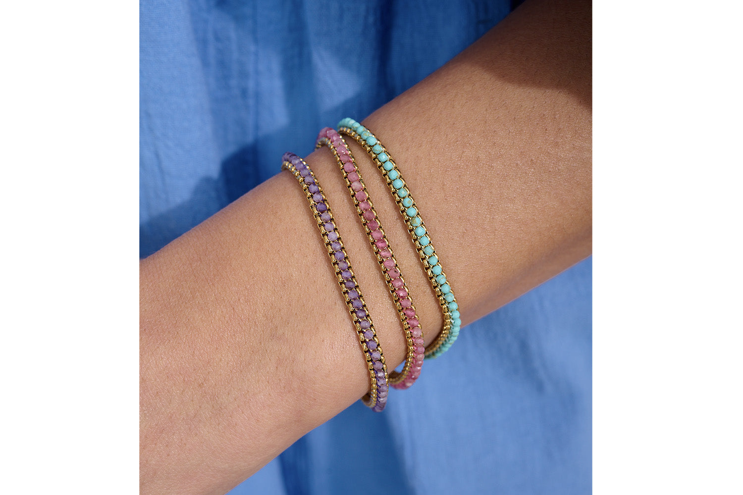 Zena Amethyst Gold Braided Bracelet styled on the wrist, showcasing rich amethyst hues and shimmering gold accents, perfect for layering or wearing solo.