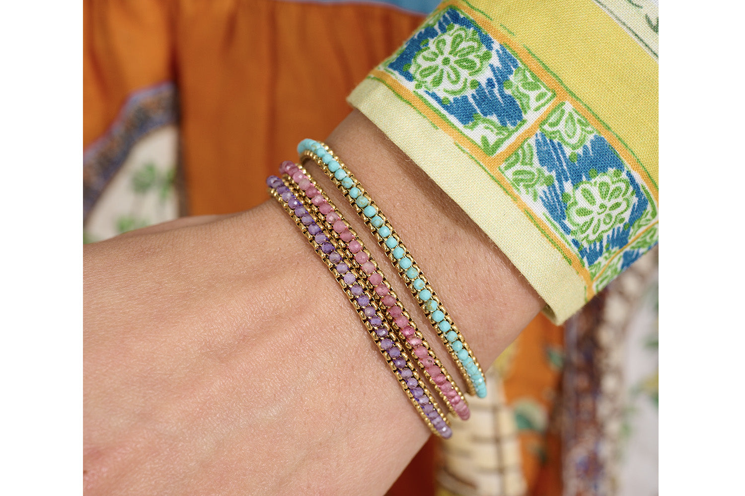 Zena Turquoise Howlite Gold Braided Bracelet styled on the wrist, showcasing rich turquoise hues and shimmering gold accents, perfect for layering or wearing solo.