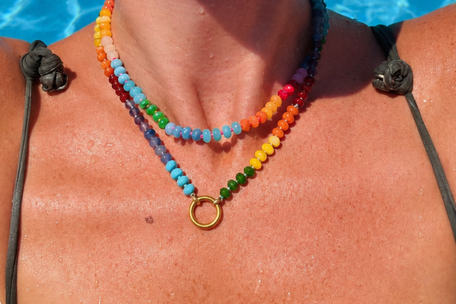 Amala Rainbow Bead Gold Charm Carrier Necklace worn layered, featuring colourful rainbow gemstone beads and a waterproof 14k Gold PVD charm carrier clasp.
