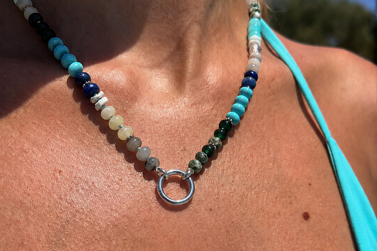 Amala Blue Bead Silver Charm Carrier Necklace worn layered, showcasing jade, shell, turquoise and labradorite beads with a waterproof white gold plated charm carrier clasp.