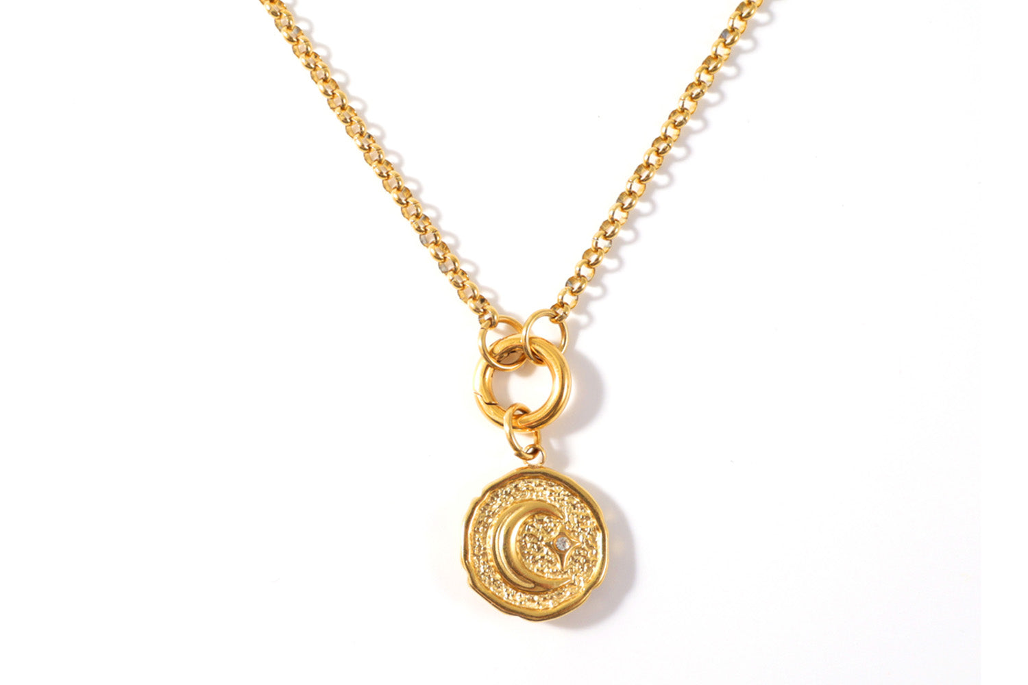 The reverse side of the Eira Pendant Necklace in gold featuring a moon.