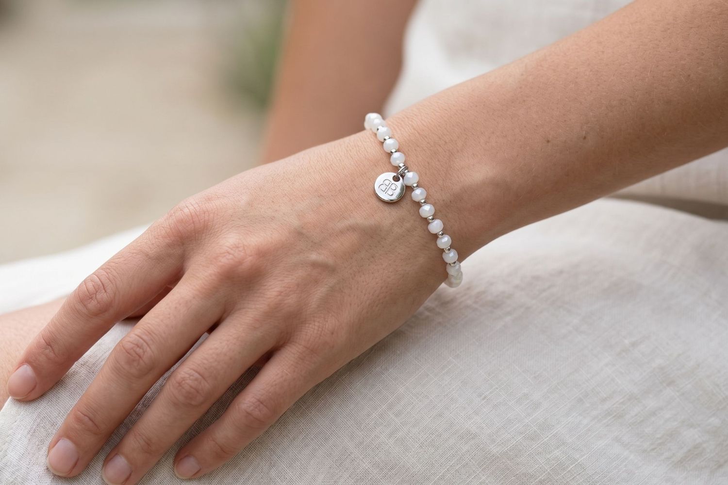 Prunus White Silver Bracelet styled on the wrist, showcasing shimmering white crystal beads and waterproof silver PVD details designed for everyday wear and effortless layering.