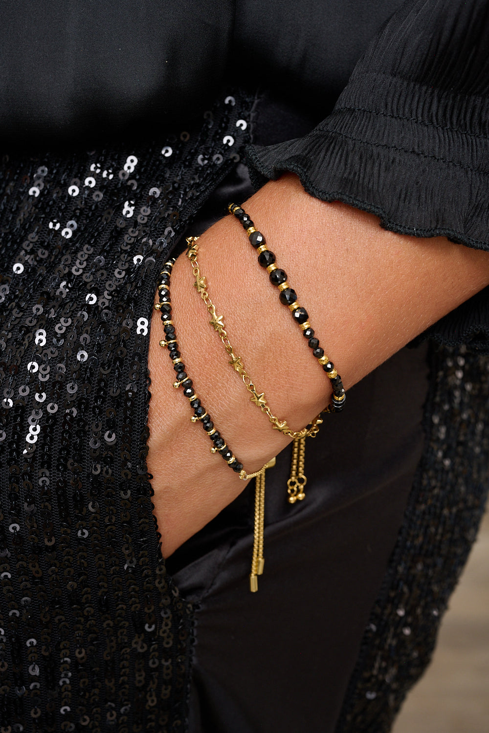 Bracelet styled on wrist with starry gold Boho Betty stacking bracelets