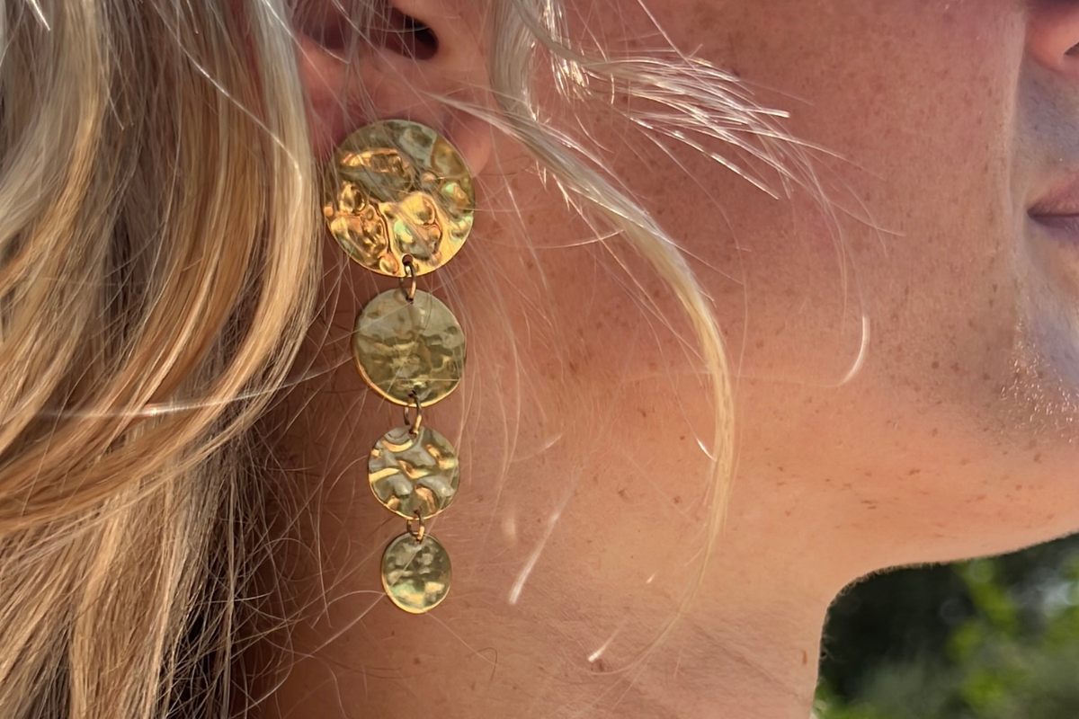 Amaya Gold Statement Drop Earrings worn with cascading hammered gold discs in waterproof 14k Gold PVD stainless steel, creating elegant movement and a bold statement.