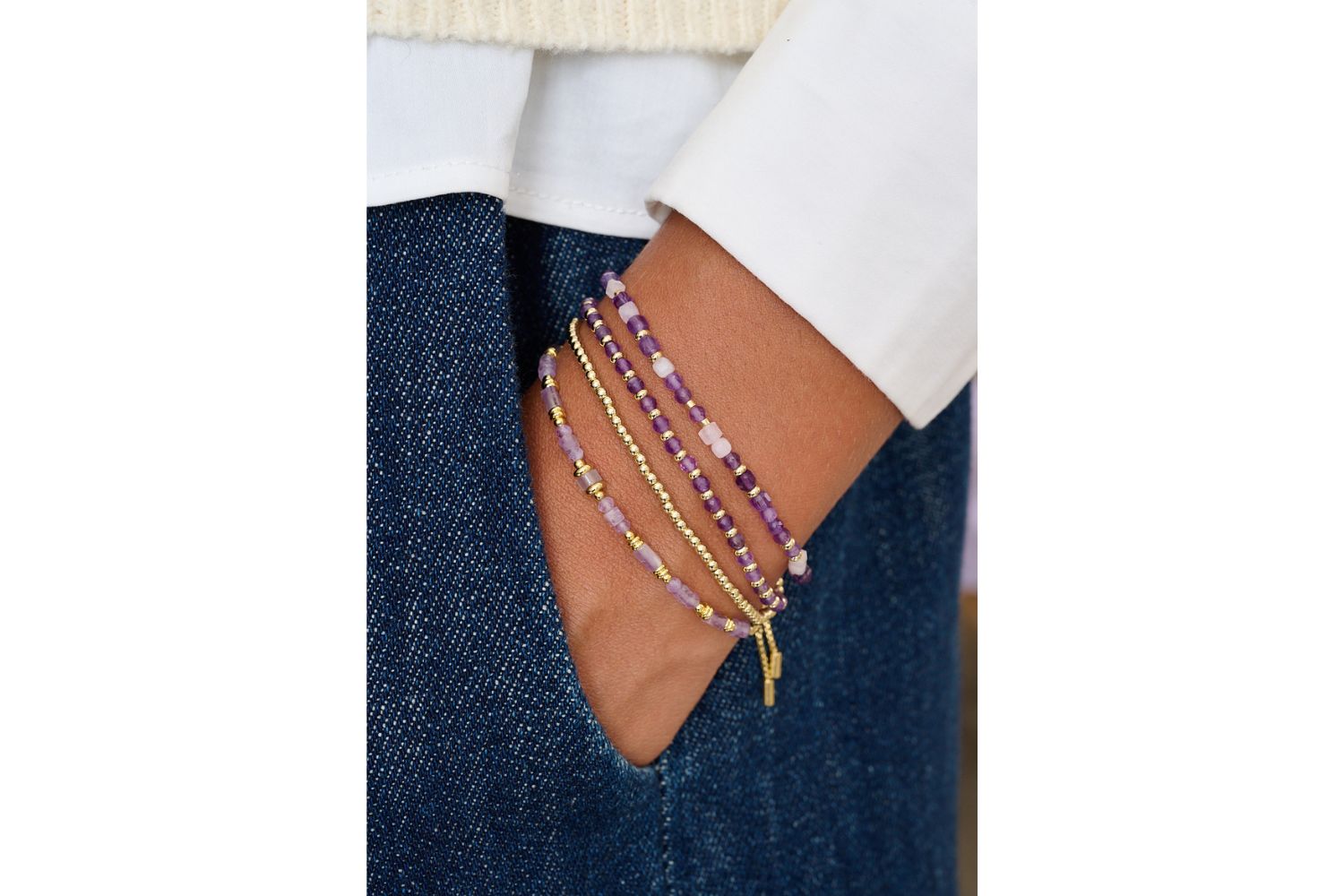 Annabelle Kunzite & Amethyst Wrap Bracelet styled in a stacked look with golden tones and soft fabrics for an elegant boho finish.