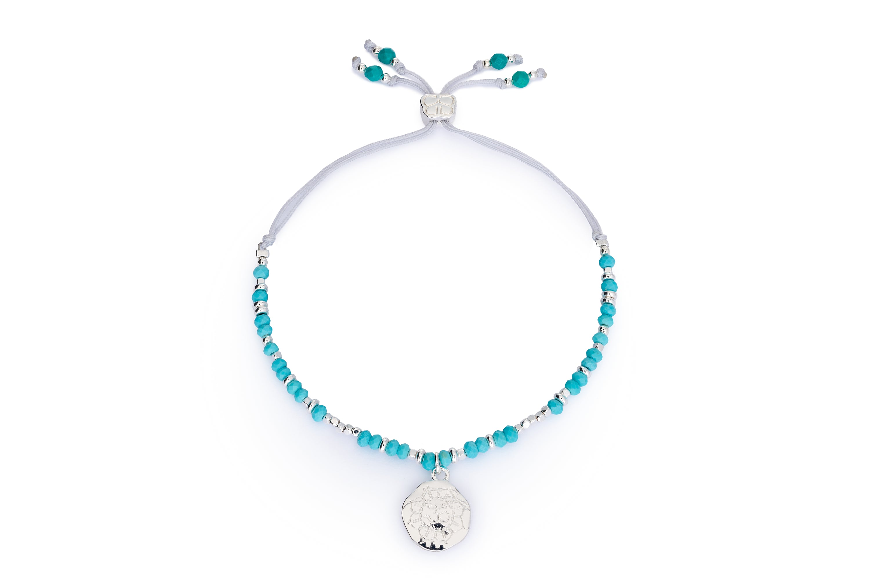 Turquoise howlite Om charm bracelet with silver accents and Boho Betty slider on white background