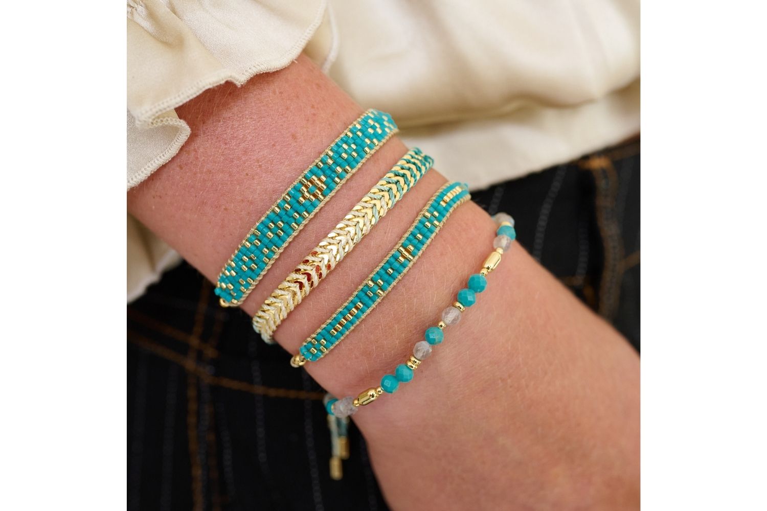 Baros Turquoise Gold Bracelet Stack styled on the wrist, showcasing turquoise gemstones and gold accents for a tropical boho chic look.