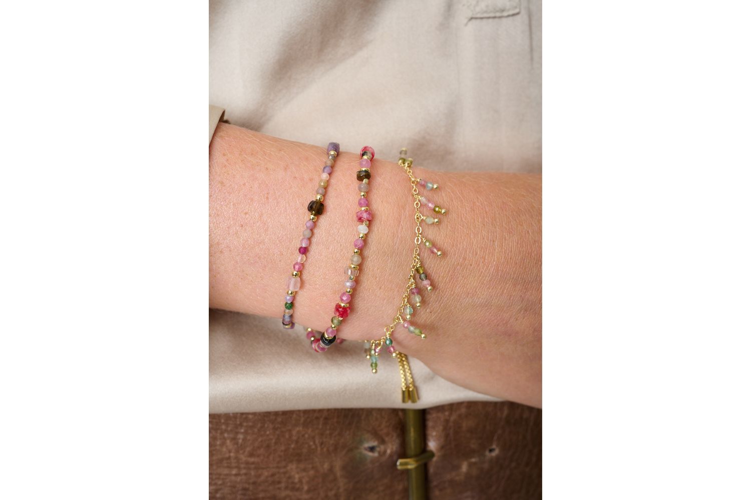 Beryl Tourmaline Mix Gold Bracelet styled on the wrist, showcasing colourful natural tourmaline gemstones and waterproof gold PVD details designed for everyday wear and effortless layering.