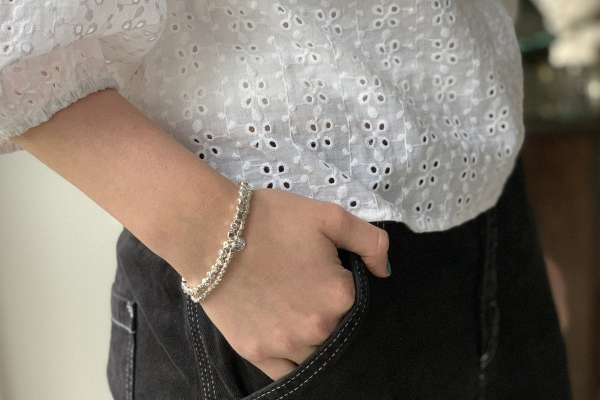 Sabal Major Silver Stretch Bead Bracelet Set styled on the wrist, showcasing waterproof stainless steel silver beads designed for everyday wear and effortless layering.