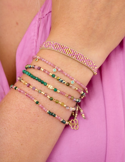 Budelli Gold, Pink Tourmaline, and Malachite Beaded Bracelet Stack styled on the wrist, featuring pink and green gemstones with gold accents, perfect for layering or gifting.