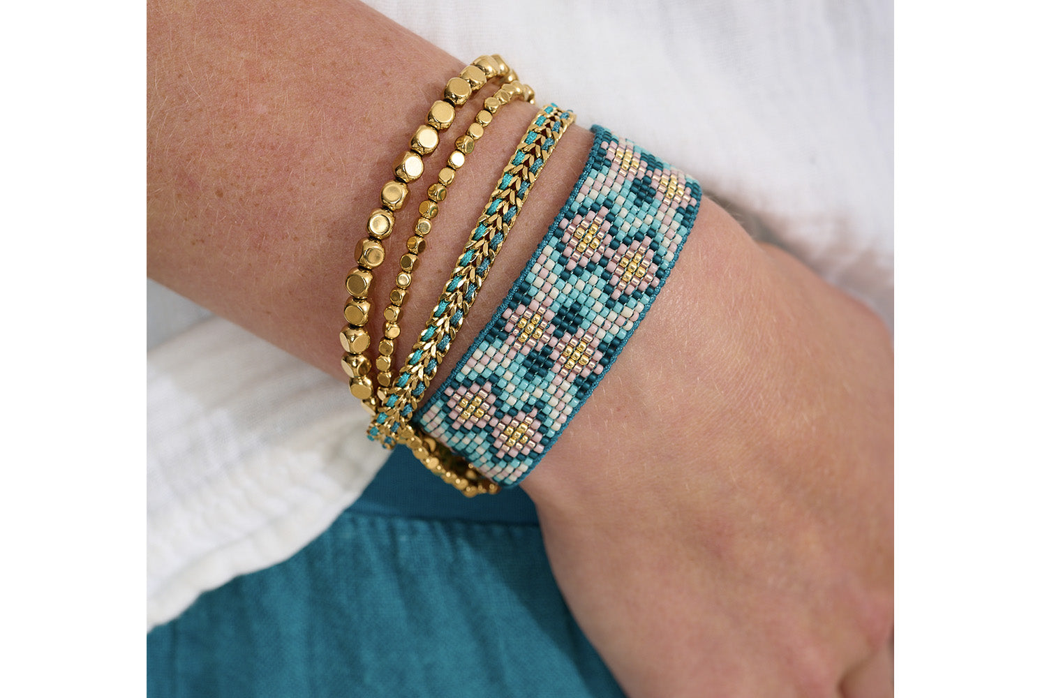 Charlotte Teal Gold Beaded Friendship Bracelet styled on the wrist, showcasing teal and gold Miyuki beads, perfect for layering with other boho jewellery or wearing solo.
