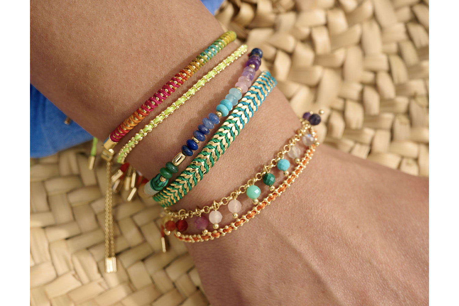 Emelia Rainbow Braided Bracelet styled on the wrist, showcasing the vibrant ombré colours and sleek gold detailing—perfect for layering or wearing solo.