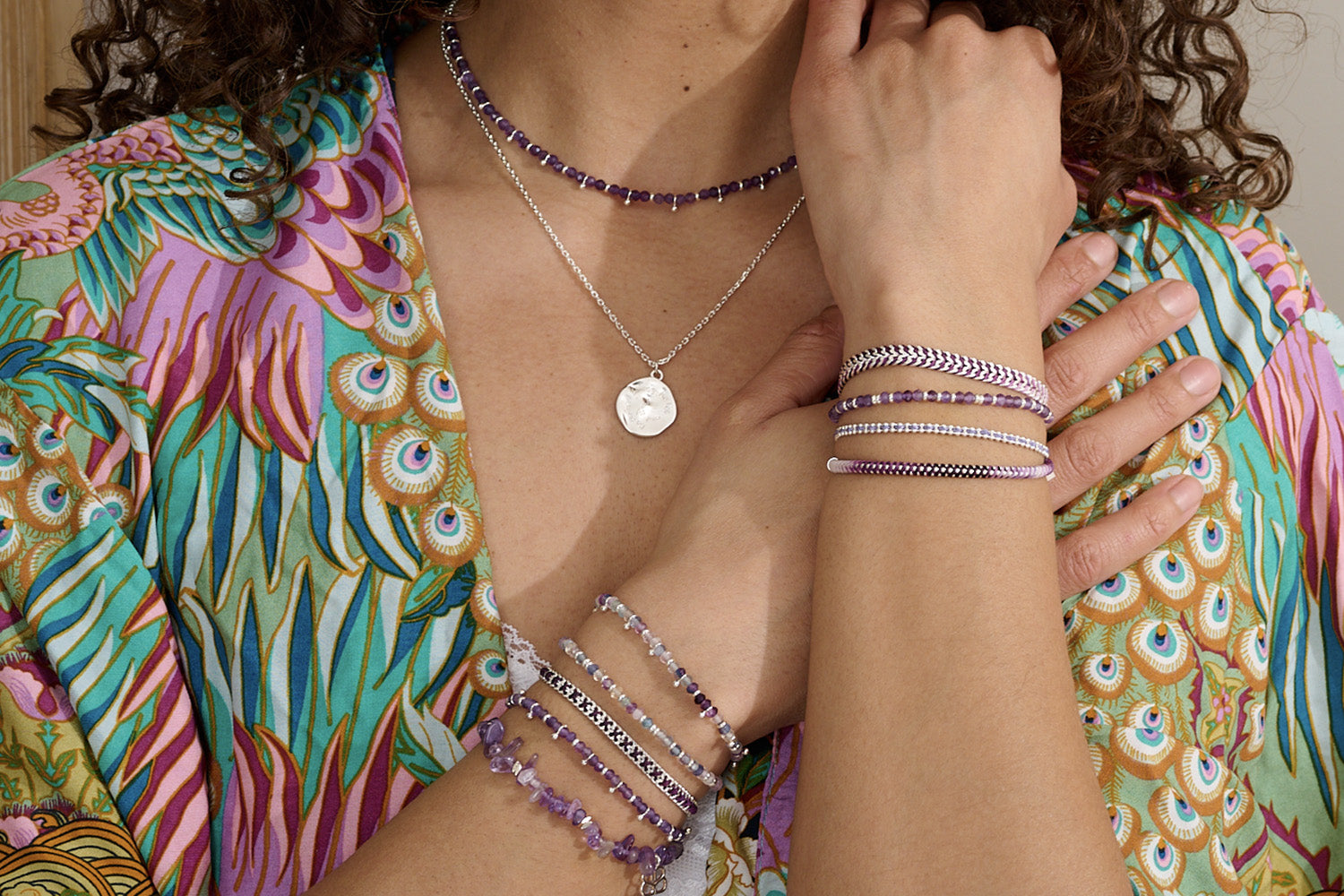 Emelia Ombre Purple Braided Bracelet styled on the wrist, showcasing the soft gradient from lilac to plum with shimmering silver chain detail—perfect for layering or wearing solo.
