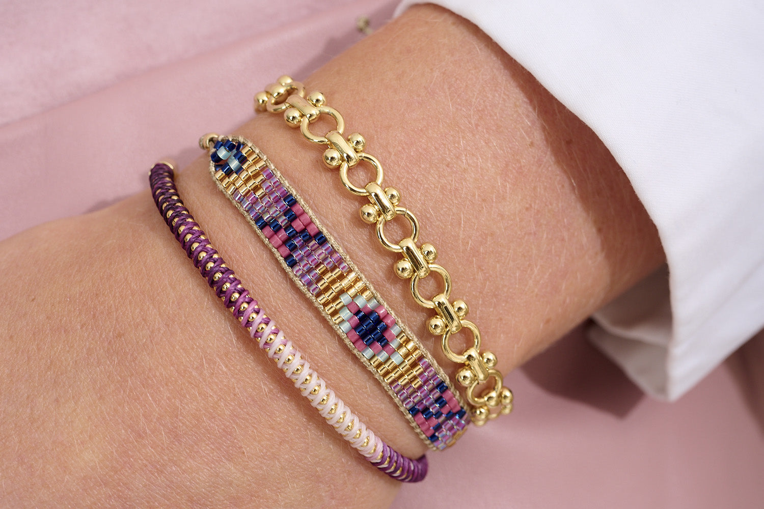 Emelia Purple Ombre Braided Bracelet styled on the wrist, showing its soft purple gradient and gold chain—perfect for layering or everyday wear.