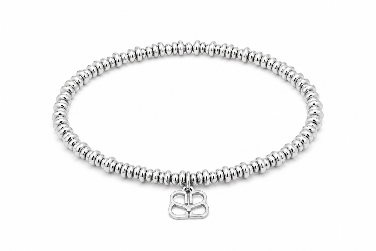 Enso Silver Bead Stretch Bracelet featuring polished silver rondelle beads, Boho Betty’s signature BB filigree charm and waterproof White Gold PVD-coated stainless steel.