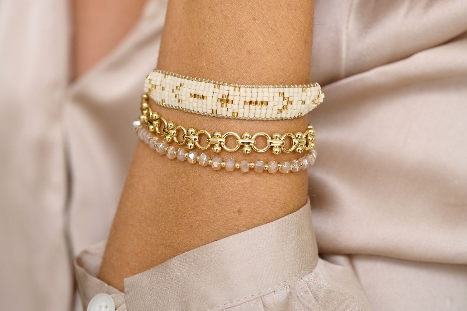 Grace Gold & Cream Beaded Friendship Bracelet styled on the wrist, showcasing cream beads and gold accents, perfect for adding warmth and elegance to any look.