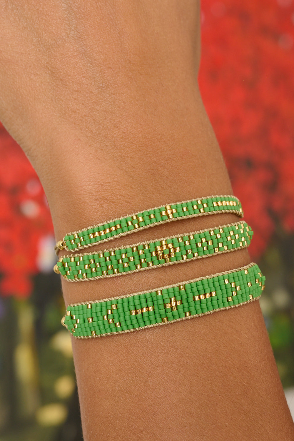 Grace green and gold bracelet featured on wrist with Boho Betty stacking bracelets Aslan and Maya.