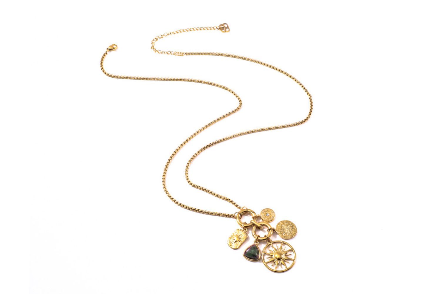 Hemani epidote charm necklace layered with gold chains in a relaxed boho look.