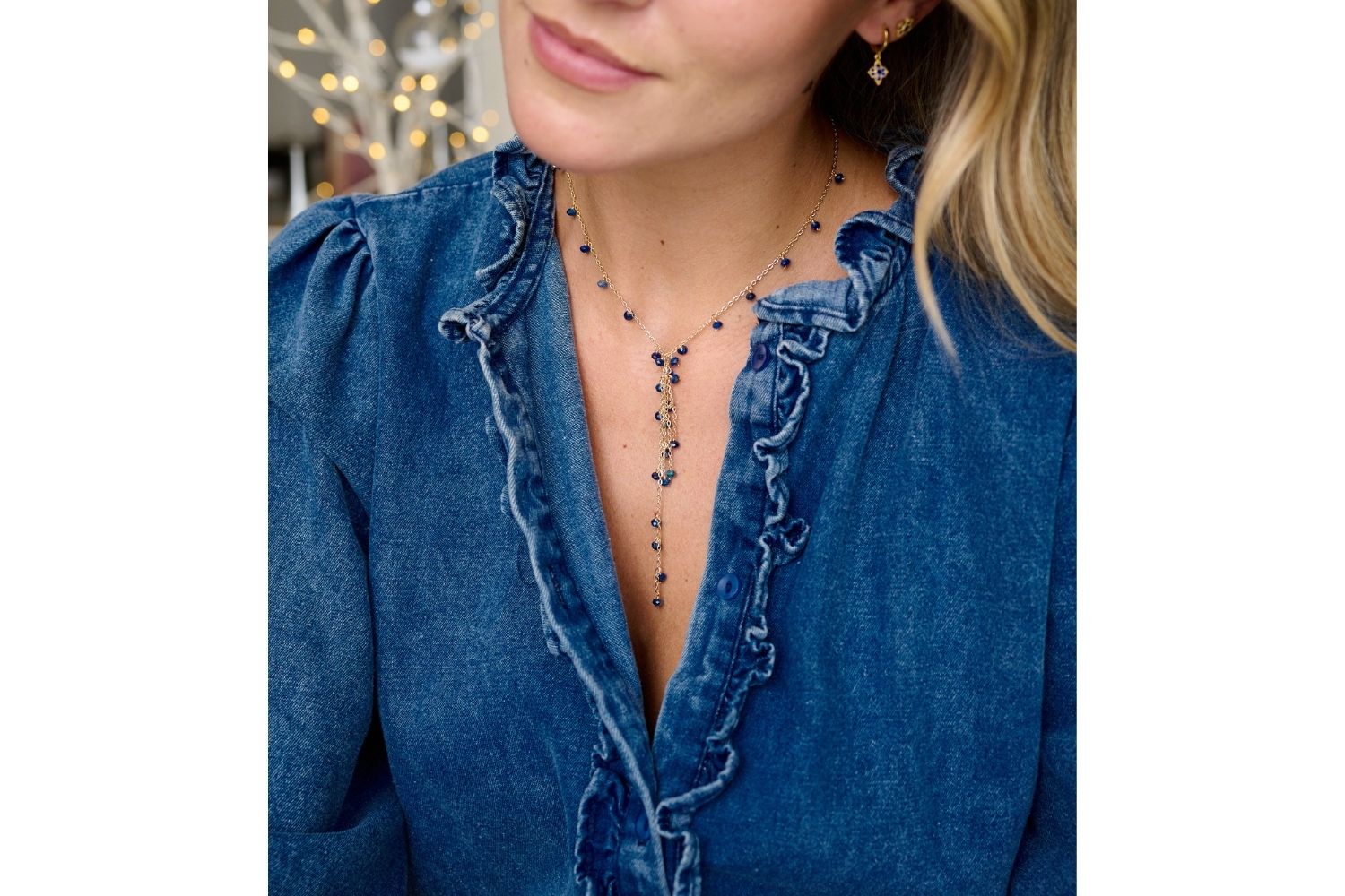 Ivy Kyanite Lariat Gemstone Necklace styled on the neck, showcasing indigo blue kyanite gemstones and a 12k gold-plated chain, ideal for evening wear or glamorous occasions.