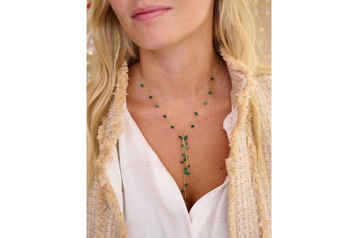 Ivy Malachite Lariat Gemstone Necklace styled on the neck, showcasing deep green malachite gemstones and a 12k gold-plated chain, perfect for evening wear or chic occasions.